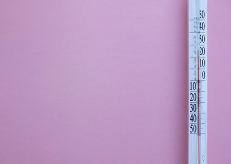 Thermometer on pink background with copy space for your text.の写真素材
