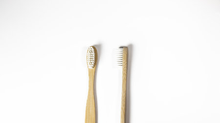 Two bamboo toothbrushes on white background, top view, copy spaceの写真素材