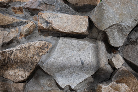 Background of stone wall texture. Macro photo of gray stone wall.の写真素材