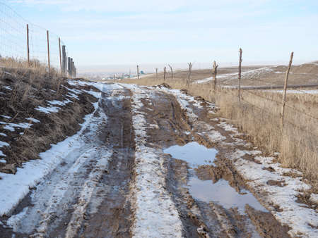 Spring melting snow, dirt road, puddles and mud. Slush.の写真素材