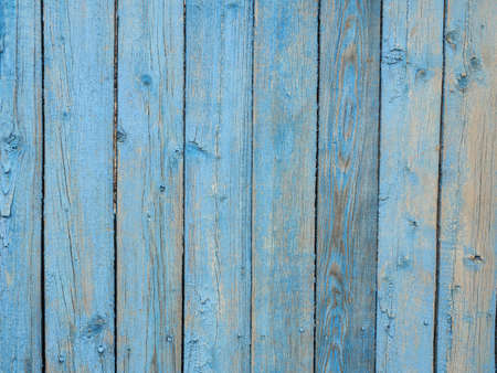 Old wooden planks covered with peeling blue paint.