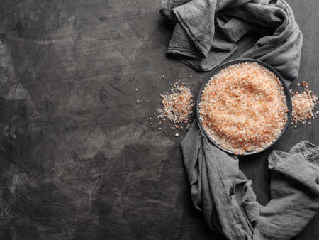 Pink Himalayan salt in a plate on a table with a gray cloth. Top view.の写真素材