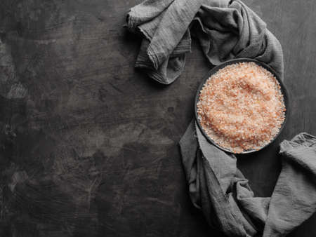 Pink Himalayan salt in a plate on a table with a gray cloth. Top view.の写真素材