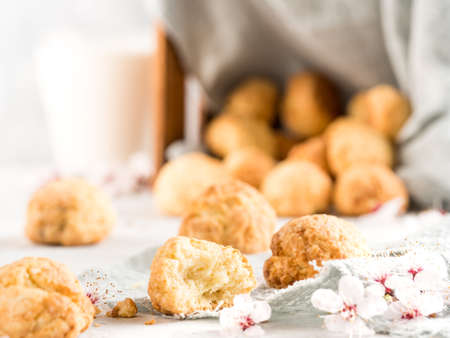 Shortbread cookies on a light background with spring flowers. Horizontal photo. Copy space.の写真素材