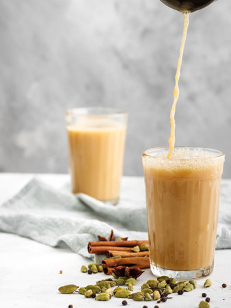 Traditional Indian drink Masala tea on a light background with spices. Copy space.の写真素材