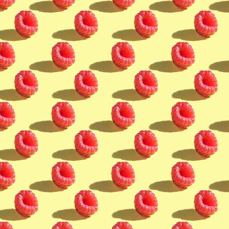 Seamless pattern of raspberries on a yellow background with clear shadows.の写真素材