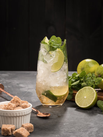 Refreshing mint cocktail mojito with rum and lime, cold drink or beverage with ice on black backgroundの写真素材