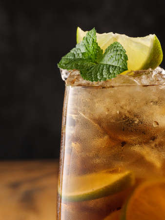 Classic cocktail Cuba Libre on a wooden table, copy space.の写真素材