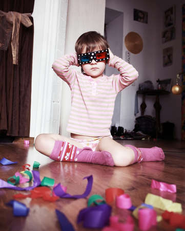 Child whit 3d glasses on a wooden floor の写真素材