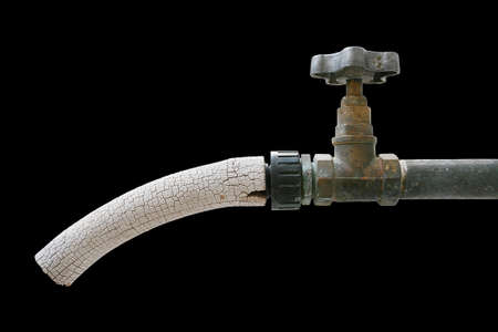 Old tap isolated on a black background.の写真素材