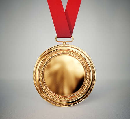 gold medal isolated on a grey backgroundの写真素材