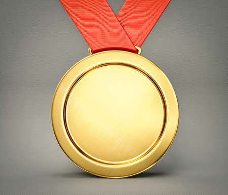 gold medal isolated on a grey backgroundの写真素材