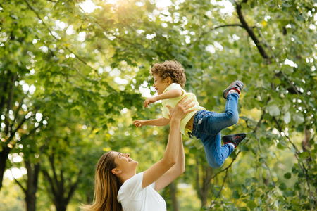 Portrait of happy loving mother and her baby outdoors.の写真素材