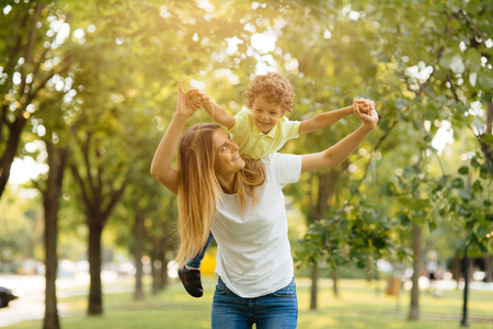 Portrait of happy loving mother and her baby outdoors.の写真素材