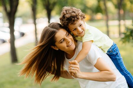 Portrait of happy loving mother and her baby outdoors.の写真素材