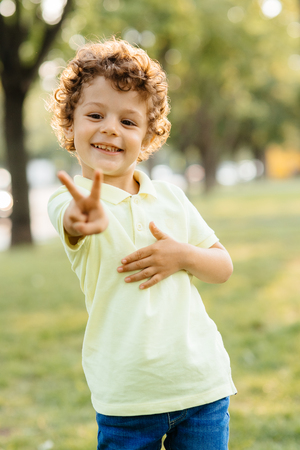 Young boy looks with fingers read years hasの写真素材