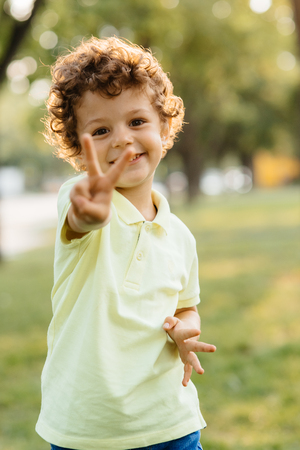 Young boy looks with fingers read years hasの写真素材