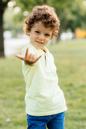Young boy looks with fingers read years hasの写真素材