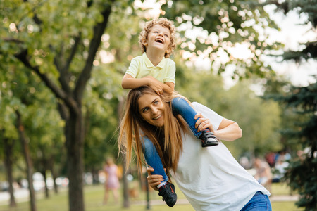 Portrait of happy loving mother and her baby outdoors.の写真素材