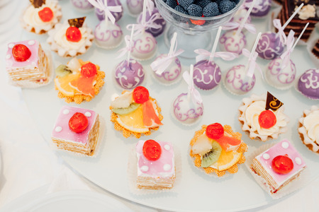 Candy bar on wedding ceremony with a lot of different candies and beveragesの写真素材