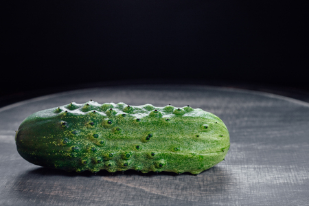 fresh cucumber, with black wood backgroundの写真素材