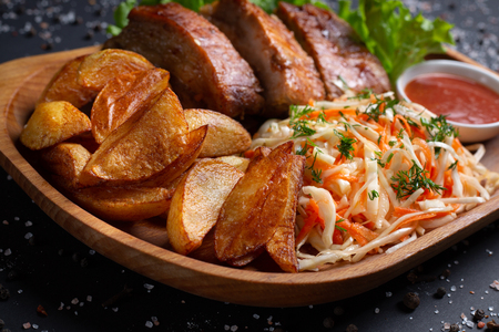 french fries with meat and salad, on black background, top viewの写真素材