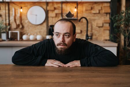 lonely young man with beard, sad in depression,の写真素材