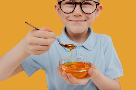 close up, Adorable boy eat honeyの写真素材