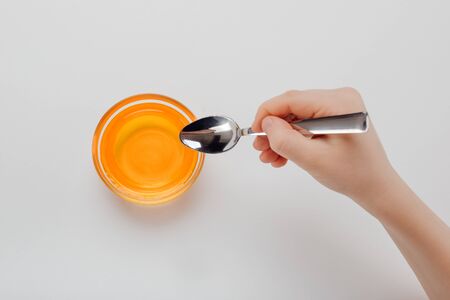 top view, childs hand with honey on the tableの写真素材
