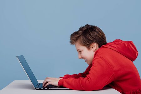 Side view Excited male teenager red sweatshirtの写真素材