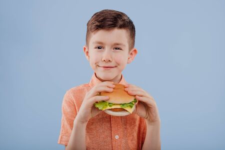 nice kid with sandwich in hand. looks at the camera,の写真素材