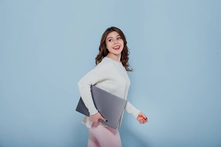 happy girl hugs a laptop, looks away,の写真素材