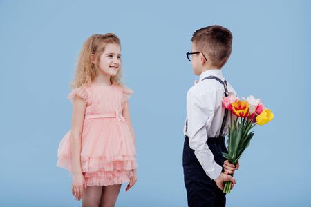 two little child boy with flowers and girl in pink dressの写真素材