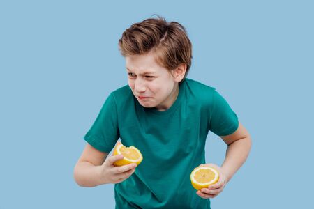 boy he feels the taste of lemon, sour taste,の写真素材