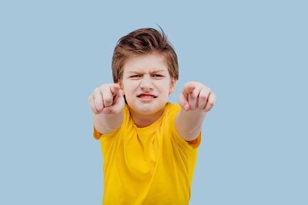 hardcore boy pointing at camera, in yellow t-shirtの写真素材