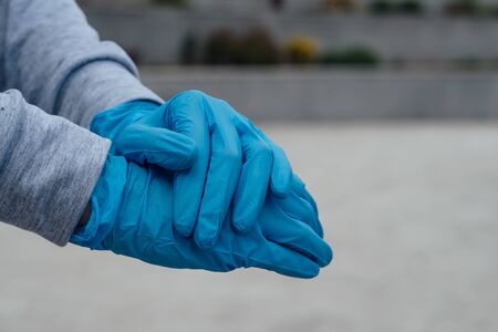 Woman hands with Protective Gloves to Prevent Transmissionの写真素材
