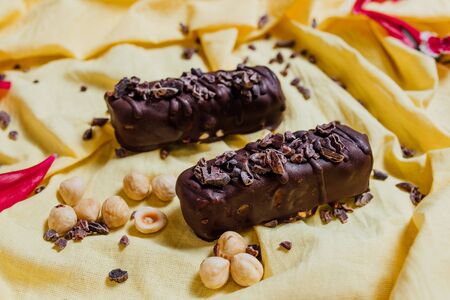 vegetarian chocolate on yellow background, top view, vegetarian sweetsの写真素材