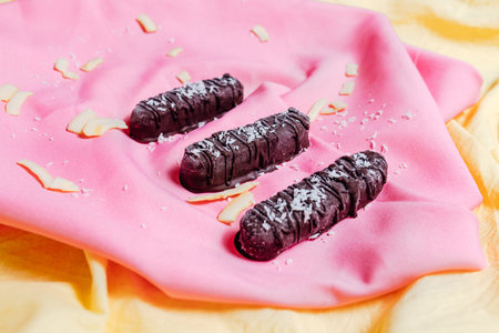 vegetarian chocolate on pink background, top view, vegetarian sweets