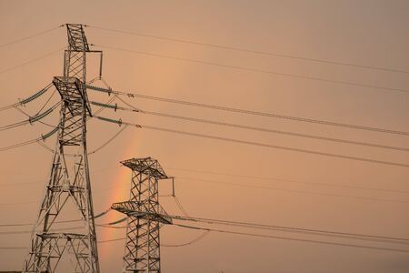 Electricity: High voltage power lines, Sunrise with pylons in Silhouette and Colorful Skyの写真素材