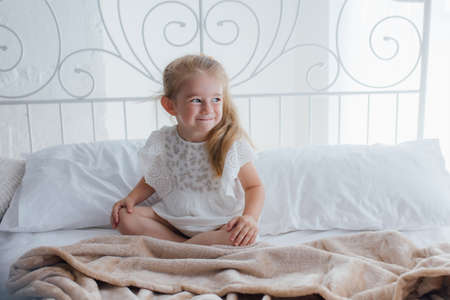 pleasant awakening for a little girl, Girl looks cheerful and full of energy in morning. Tips having pleasant morning every day. Enjoy awakening and feel good.の写真素材