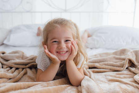 Good morning. pleasant awakening for a little girl, Girl looks cheerful and full of energy in morning. Tips having pleasant morning every day. Enjoy awakening and feel good.の写真素材