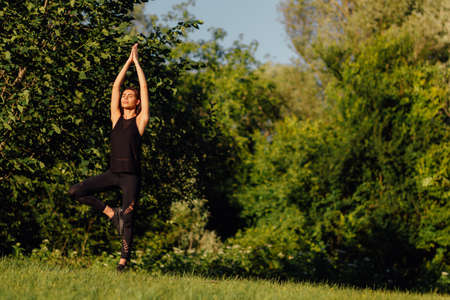 Healthy Yoga woman lifestyle balanced practicing meditate and energy yoga on the bridge in morning and sunset outdoors nature. Healthy life Conceptの写真素材