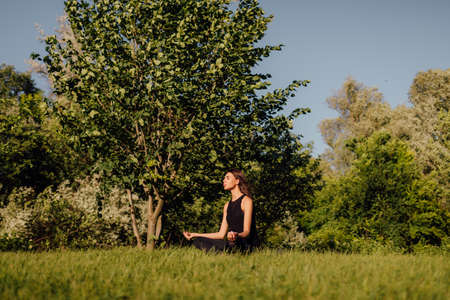 Yoga woman in meditation pose, healthy lifestyle, outdoorsの写真素材