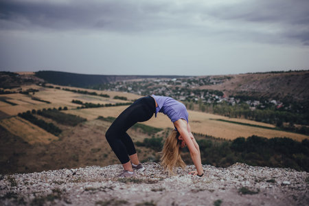Practicing yoga in nature. Active living concept. Taking care of your health. Reducing stress by...