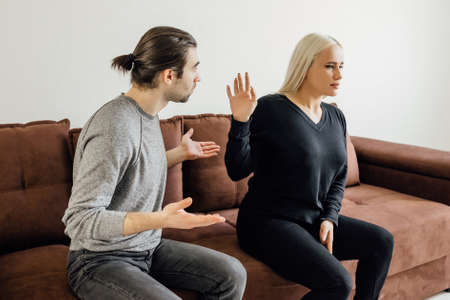 the man verbally assaults his wife. Aggressive woman keeps her husband's morale. Relationship Crisis Concept.の写真素材