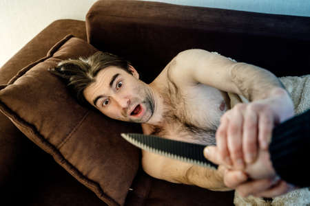 male Trying To Kill Man who sleeps With Knife. scared man defends himself from killerの写真素材