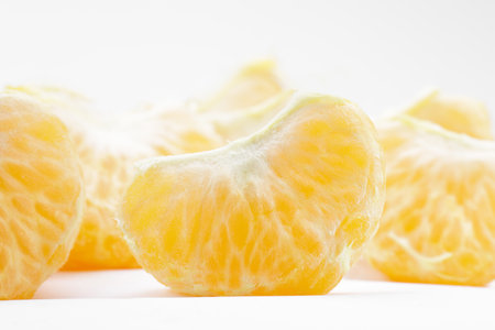 citrus segments. Collection of tangerine, orange and other citrus fruits peeled segments isolated on white background.の写真素材