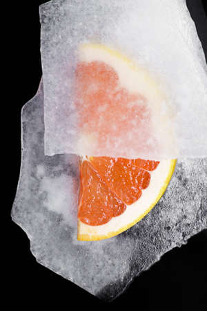 Delicious and beautiful grapefruit. So fresh !. Grapefruit slices on ice slice. Close-up. pink grapefruit, over background of slice iceの写真素材