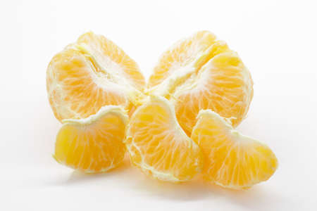 Isolated tangerine or clementine fruit on white background. Macro. Slice of mandarin. citrus fruits peeled segments isolated on white background.の写真素材