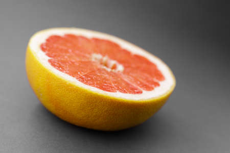 Grapefruit half on gray background. Top view or flat lay. Copy space for text.の写真素材